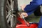 Car mechanic loosen wheel nuts in a workshop