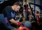 Car mechanic mounts tire on wheel in a workshop