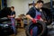 Car mechanic mounts tire on wheel in a workshop