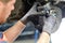 Car mechanic repairs breakes from vehicle in a workshop