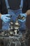 Car mechanic in rubber gloves holds in his hands gears and modes from a mechanical gearbox. Repair of manual transmission in a car