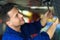 Car mechanic working on the underside of a car