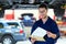 Car mechanic working on the underside of a car