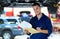 Car mechanic working on the underside of a car