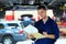 Car mechanic working on the underside of a car