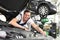 car mechanic in a workshop - engine repair and diagnosis on a vehicle