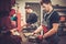 Car mechanics working at work table in auto repair service.