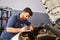Car mechatronic fills out checklist for inspection
