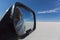 Car mirror with view of the awesome salt flats of Uyuni with clear blue sky