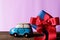 A car model carrying a gift box, delivering love. Happy Valentine& x27;s day concept