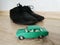Car model toy in comparison with male shoes