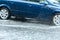 Car in motion during heavy rain, flooded street