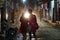 Car and motorbike headlights illuminate two women walking down dark street.