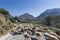 Car on a mountain road surrounded by a herd of sheep. Crete,