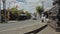 A car moving along the road with special people watering the street from spray with chemical reagents to protect against the virus