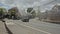 A car moving along the road with special people watering the street from spray with chemical reagents to protect against the virus