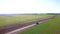 The car on the nature. Fotage. Black car driving on rural road. Aerial