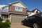 Car near garage of new two-storied cottage