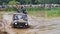 The car overcomes difficult obstacles. Large-scale sports competitions of off-road cars