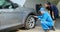 Car owner and mechanic checking flat tyre