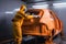 Car painter in protective clothes and mask painting a car, mechanic using a paint spray gun in a painting chamber. Bodywork, paint