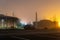 A car park on an empty industrial estate on a misty winters night. With a blurred, out of focus edit