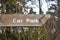 Car park sign on wooden post with arrow pointing right