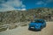 Car parked in the roadside on rocky landscape