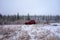 A car parked during a snow shower at a remote location in alaska