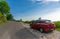 The car is parked by tourists on the roadside of serpentine for sightseeing.