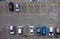 Car parking aerial top view. Occupied and vacant lots with vehicles. Park marked area of modern urban structure. City landscape