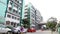 Car parking and people walking outside at the Government Hospital at Chennai, India.