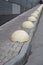 Car parking stops lined up along sidewalk, urban background