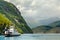 Car and passenger ferry crossing the fjord with mountain landscape in the background, Tafjord, More og Romsdal county, Norway.