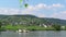 Car and passenger ferry from Ellenz towards Beilstein at Moselle River. View over vineyards