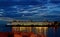 Car and passenger transport ferry docked in pier at night