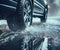 Car passing through a flooded road with a large puddle.