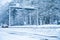 A car passing through a sign portal in a snowy and cold wooden landscape