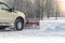 Car pickup cleaned from snow by a snowplough during wintertime