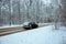 Car quickly driving through the woods to the asphalt road covered with snow