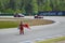 Car races on the circuit in Brno in the Czech Republic. Two cars on the track and a marshal from a red flag.