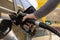 Car refuelling on the petrol station. Man refilling the car with fuel. Close up view. Gasoline, diesel is getting more