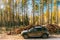 Car Renault Duster SUV in autumn forest landscape. Duster produced jointly by French manufacturer Renault and its