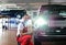 Car repair shop - worker checks and adjusts the headlights of a