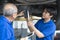 Car repairs. Auto services and Small business concepts. Asian business owners are recommending car repairs to auto mechanics