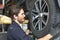 Car repairs. Auto services and Small business concepts. The car service mechanic is replacing the wheels. Removing the wheel