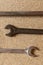 Car repairs. Tools for repair wrenches lie on a light background, three keys