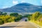 Car on road in Costa Smeralda in Sardinia Island hills