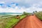 Car on the road with a couple of animals on the side. Ngorongoro Crater, Tanzania.