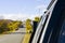 Car on the road, highway, autumn tree, plants and blue cloudy sky